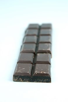 Dark Chocolate isolated against a blue background