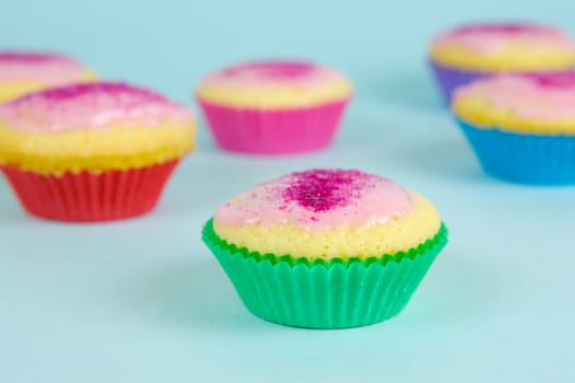 Cup cakes isolated against a blue background