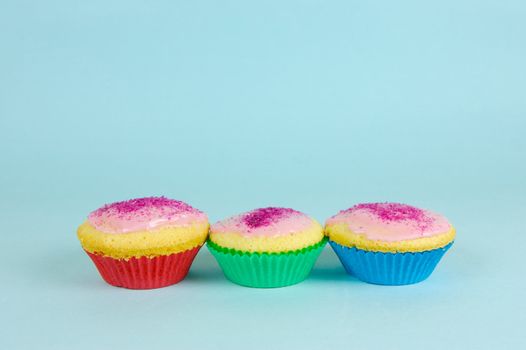 Cup cakes isolated against a blue background