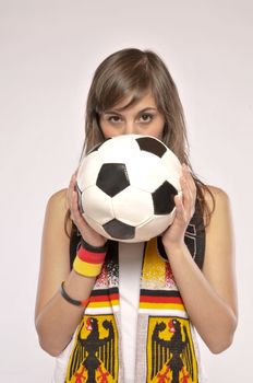 Serious Soccer Fan Girl Holding The Ball In Front Of Her Face
