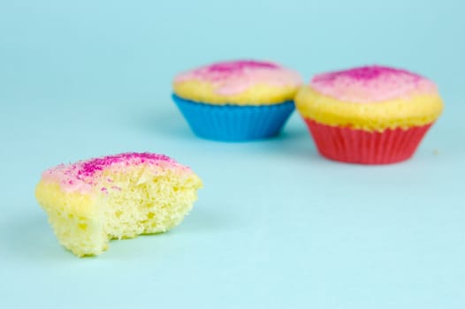 Cup cakes isolated against a blue background