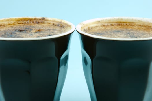 Cappuccinos isolated against a blue background