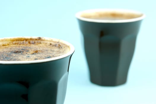 Cappuccinos isolated against a blue background