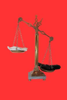 an antique scales against a red background with drugs and gun depicting drug crime with clipping path