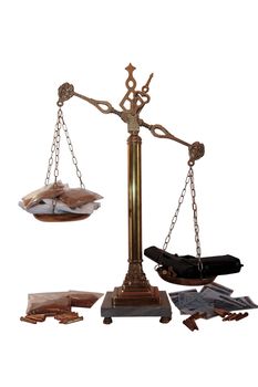 an antique scales against a white background with drugs and gun depicting drug crime