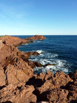 Red rocks of cliffs and mediterranean sea at Esterel massif, south of France, by beautiful weather