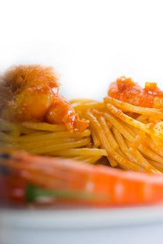 italian spaghetti pasta and fresh spicy shrimps sauce over white