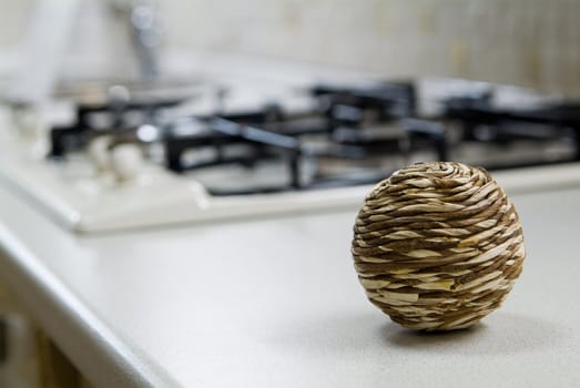 Straw sphere on the kitchen table near gas stove