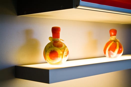 Two decorative bottles on light table on kitchen