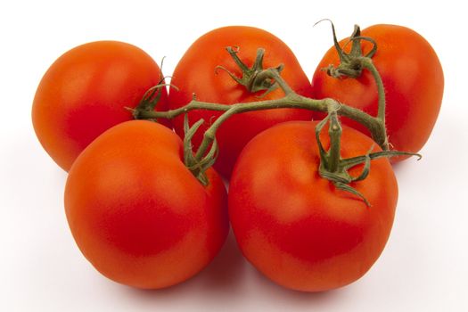 Five fresh tomatoes, isolated on white background