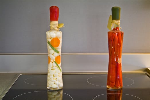 Decorative bottles on the black ceramic surface on the kitchen