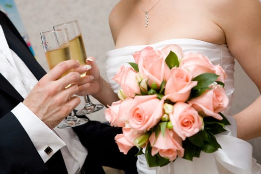 champagne in hands of bride and groom