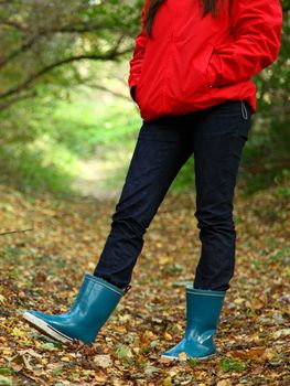 Autumn walk with. Woman walking in the forest on a beautiful fall day.