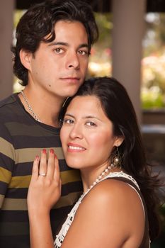 Attractive Hispanic Couple Portrait Enjoying Each Other Outdoors.