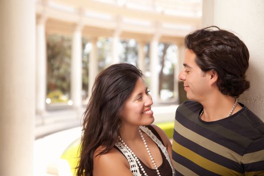 Attractive Hispanic Couple Portrait Enjoying Each Other Outdoors.