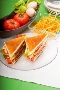 fresh and delicious classic club sandwich over a transparent glass dish