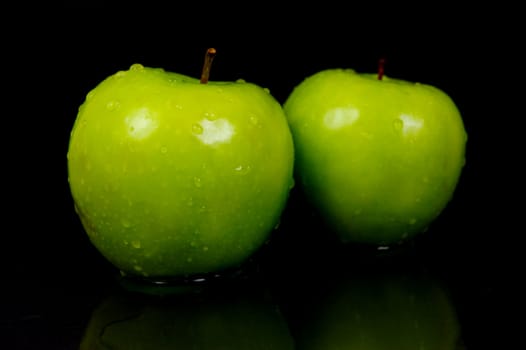 Green Apples isolated against a black background