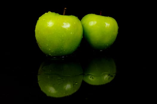 Green Apples isolated against a black background