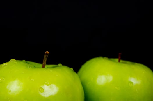 Green Apples isolated against a black background