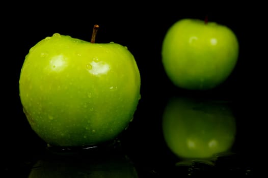 Green Apples isolated against a black background