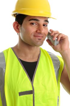 A builder, labourer, tredesman, using a cordless telephone and smiling in a friendly manner.  White background.