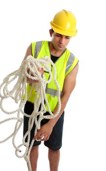 Builder, tradesman or construction worker at work gathering rope.  White background.