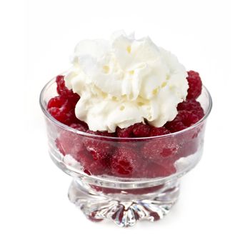 Fresh red raspberries with whipped cream in glass bowl isolated on white