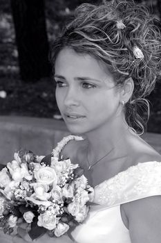 Porait of beautiful bride holding bouquet of flowers.