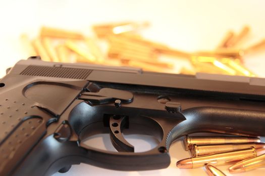 gold ammo and a handgun depicting gun culture