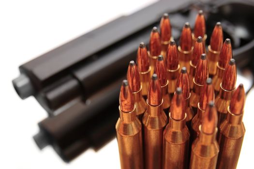 gold ammo and a handgun depicting gun culture