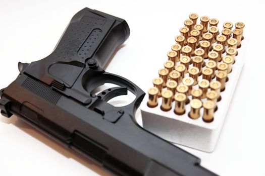 gold ammo and a handgun depicting gun culture