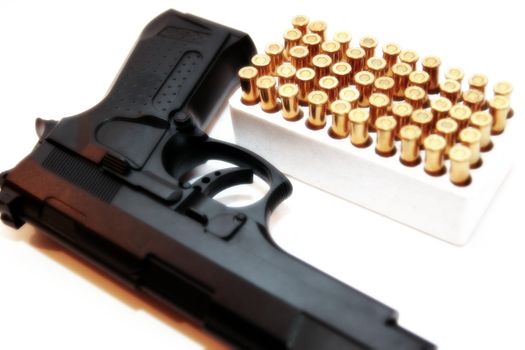 gold ammo and a handgun depicting gun culture