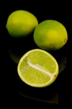 Lime citrus fruits isolated against a black background
