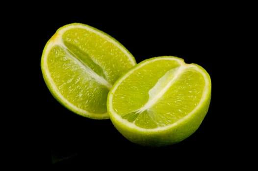 Lime citrus fruits isolated against a black background