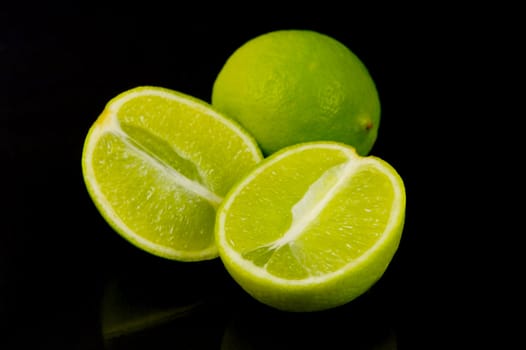 Lime citrus fruits isolated against a black background