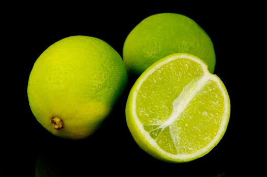 Lime citrus fruits isolated against a black background