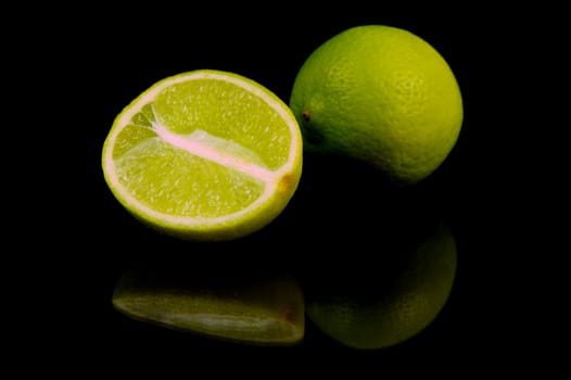 Lime citrus fruits isolated against a black background