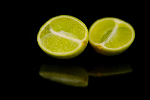 Lime citrus fruits isolated against a black background