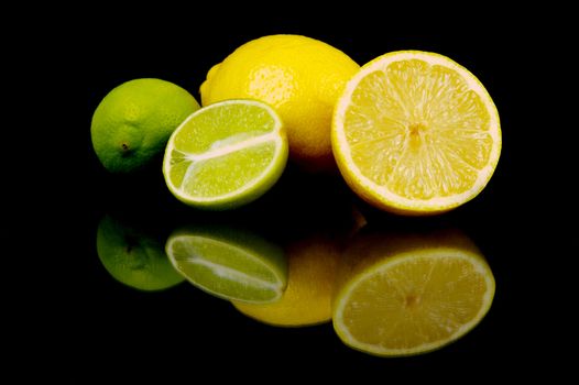 Lemon and lime citrus fruits isolated against a black background