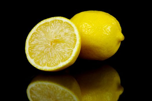 Lemon citrus fruits isolated against a black background