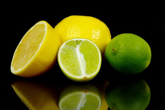 Lemon and lime citrus fruits isolated against a black background