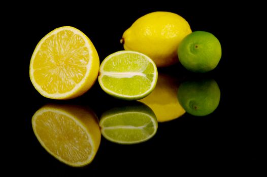 Lemon and lime citrus fruits isolated against a black background