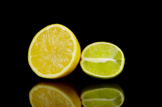 Lemon and lime citrus fruits isolated against a black background