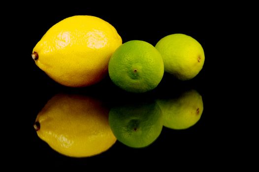 Lemon and lime citrus fruits isolated against a black background