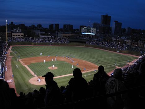The Cubs home ballpark with fans during a night game
