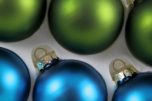 A package of green and blue Christmas baubles.