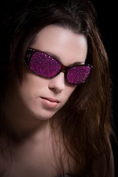 Woman with sunglasses covered in pink glitter