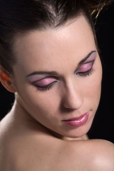 Beautiful brunette with pink eyeshadow with her eyes closed