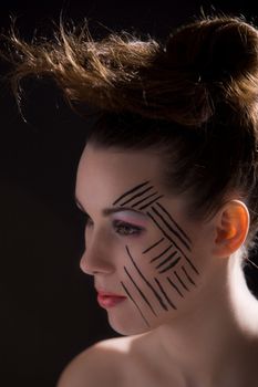 Beautiful brunette with extreme makeup and wild hairstyle