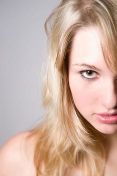 Beautiful young girl in closeup portrait on light grey background